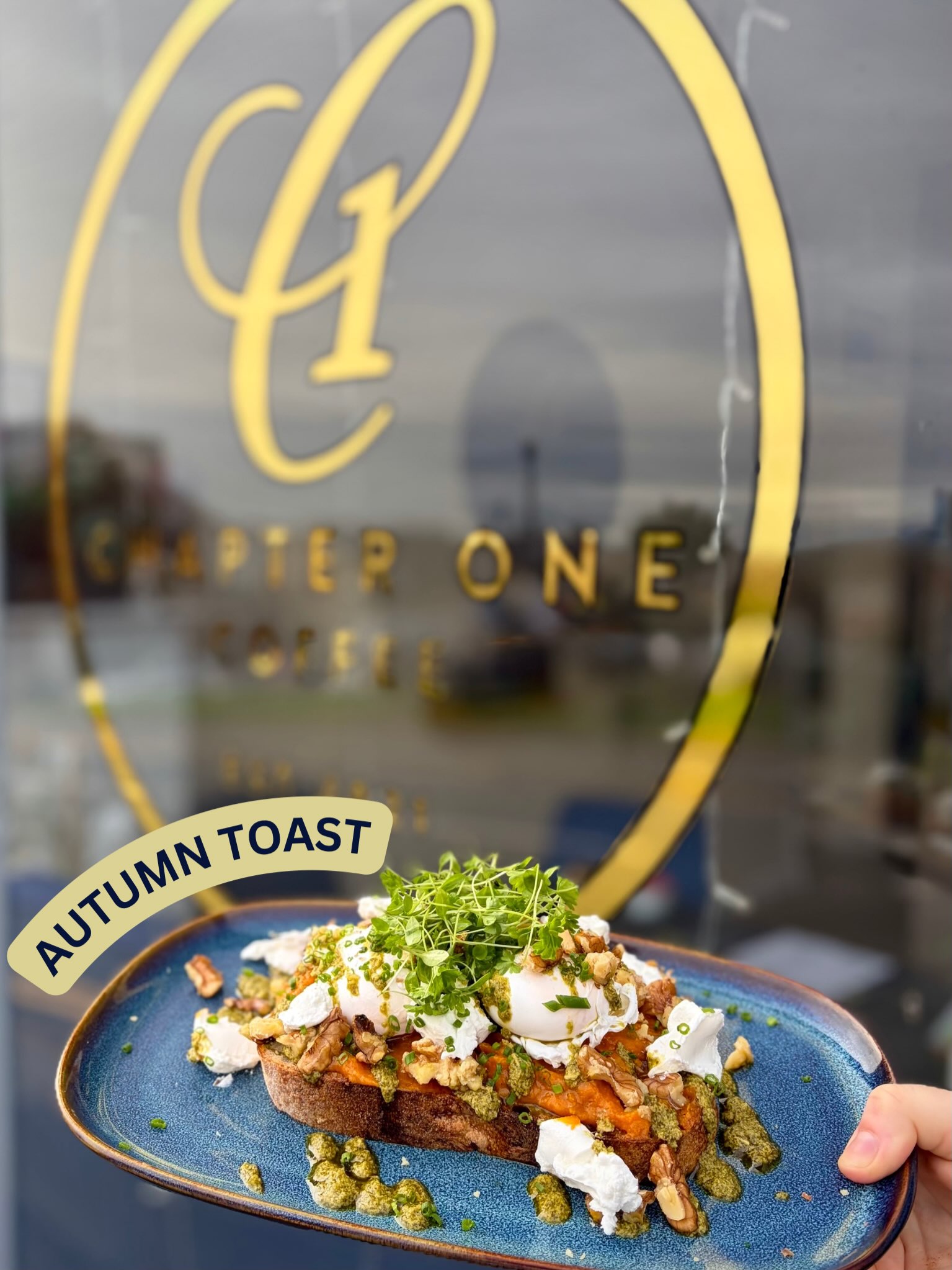 Autumn Toast held up in front of the Chapter One window